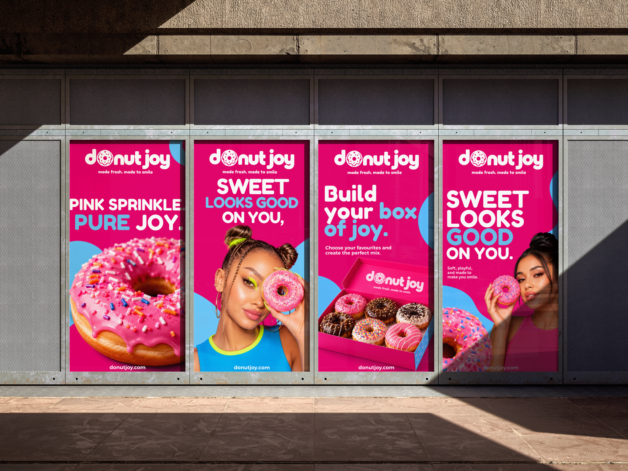 Four Donut Joy posters running along a street hoarding